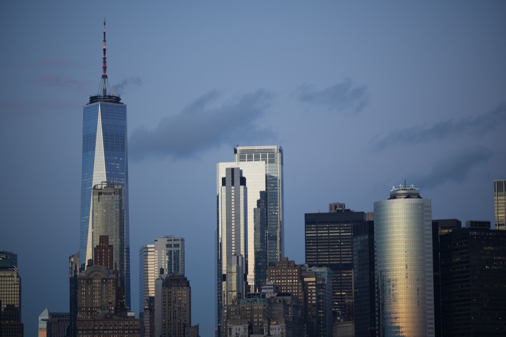 One World Trade Center and neighboring buildings in the fading evening light.